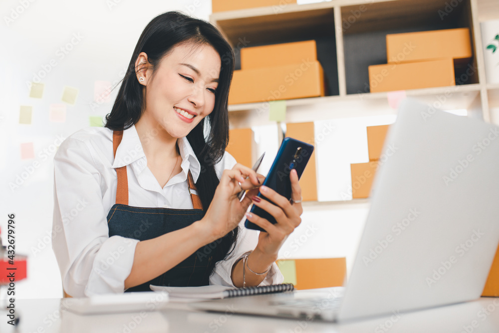 Portrait of Starting small businesses SME owners female entrepreneurs working, box and check online orders to prepare to pack the boxes, sell to customers, sme business ideas online. Portrait of Starting small businesses SME owners female entrepreneurs working, box and check online orders to prepare to pack the boxes, sell to customers, sme business ideas online.