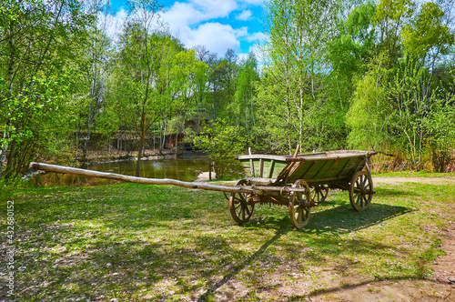 The old wooden cart at the lake, Mamajeva Sloboda Cossack Village, Kyiv, Ukraine photo