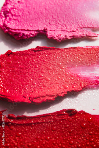 Lipstick or lip gloss swatch macro wallpaper. Beauty horizontal smears texture. Liquid makeup closeup.