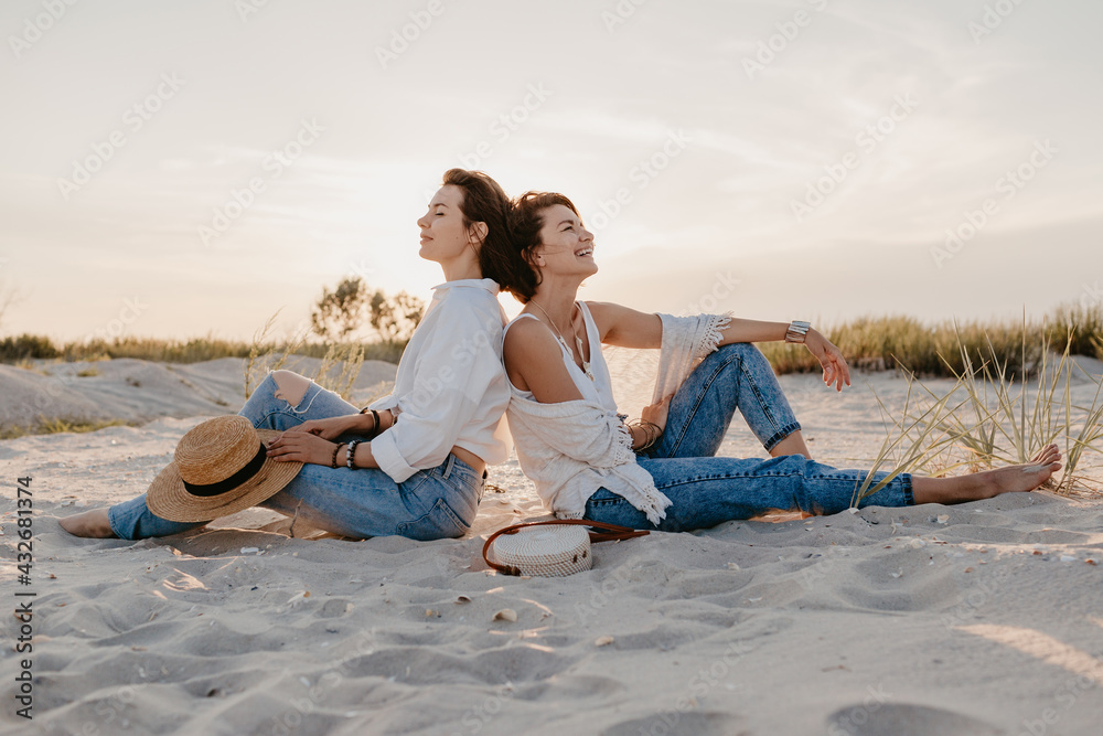two young women having fun on the sunset beach two young women having fun on the sunset beach