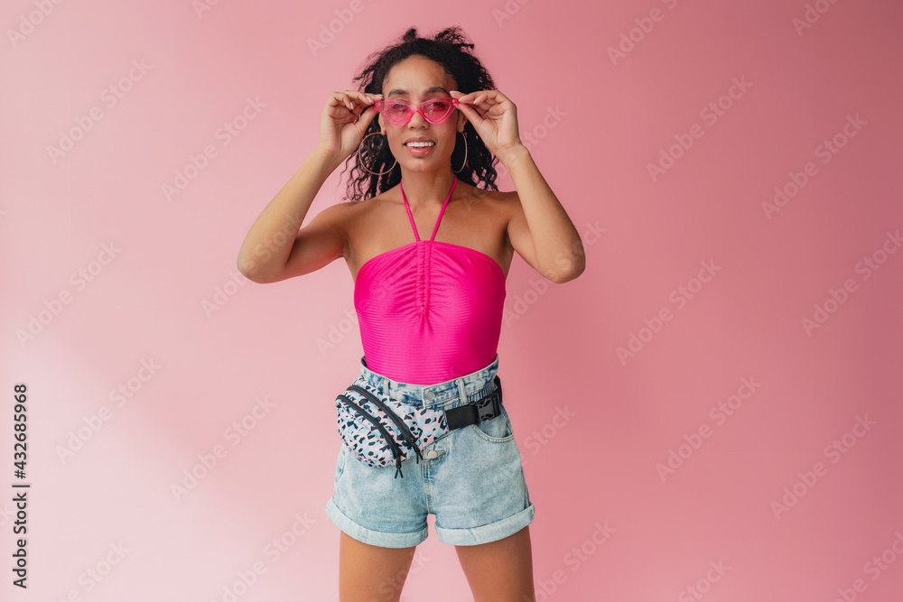 attractive black african american woman in stylish outfit on pink background attractive black african american woman in stylish outfit on pink background