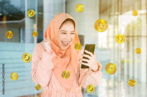 Photography Happy Muslim woman getting cryptocurrency coins