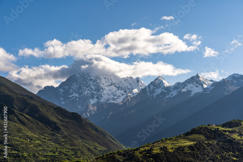 Landscape of Siguniang mountain or Four girls mountains with snow cap on top and  plants located in Xiaojin County of the Aba Tibetan and Qing Autonomous Prefecture in western Sichuan Province.