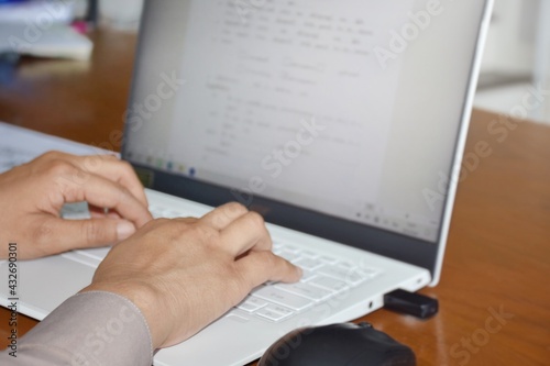 Thai teachers in Thai government uniforms are working on a computer