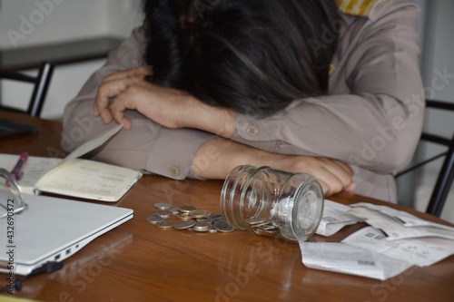 Thai government officials in uniform are stressed by lack of money, indicating the poor financial condition in the household.