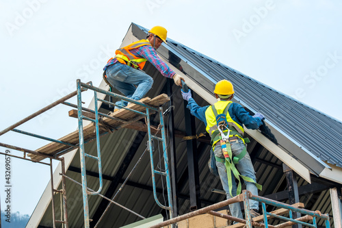 Roofer worker installing new roof on top roof,New House Construction,Roofing Job.