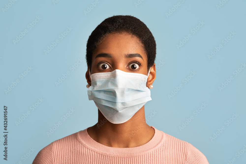 Coronavirus Panic Concept. Portrait Of Terrified African Woman In Protective Medical Mask Coronavirus Panic Concept. Portrait Of Terrified African Woman In Protective Medical Mask