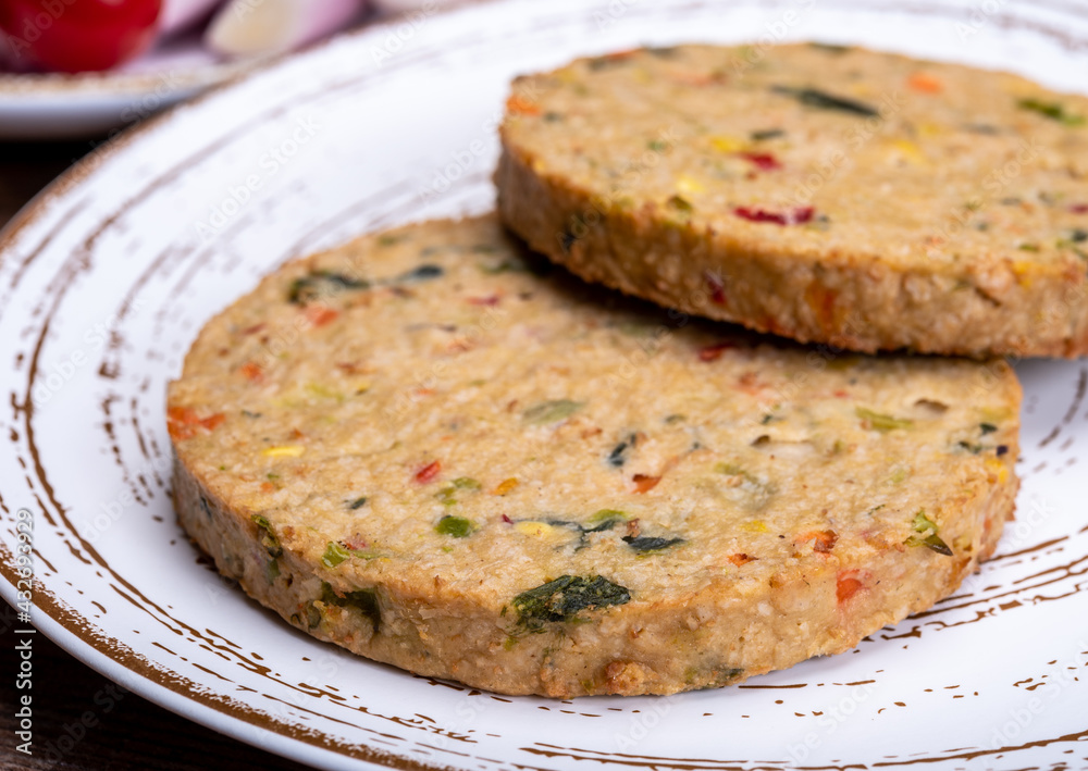 Round vegetarian patties or burgers made from grains, vegetables and legumes Round vegetarian patties or burgers made from grains, vegetables and legumes