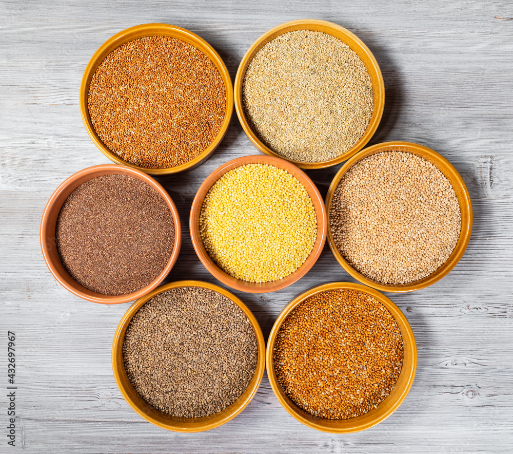 top view of millet grains in round ceramic bowls top view of millet grains in round ceramic bowls