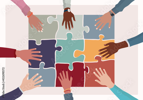 Agreement or affair between a group of colleagues or co-workers.Hands joining puzzle pieces on a table.Diversity People Exchange of ideas. Concept of sharing and exchange.Community