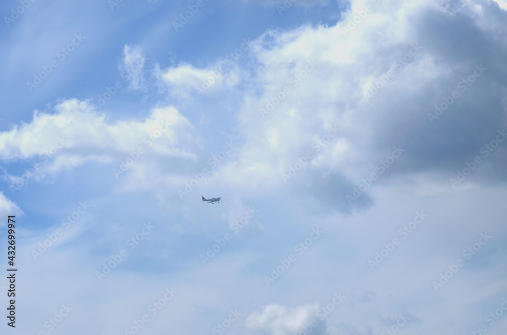 Against the background of the sky covered with clouds, the plane flies
