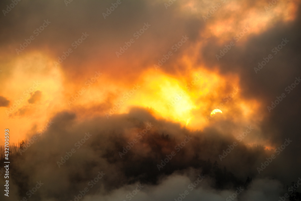 Fiery burst of sunlight break in the dark clouds - beautiful spectacular sunset Fiery burst of sunlight break in the dark clouds - beautiful spectacular sunset