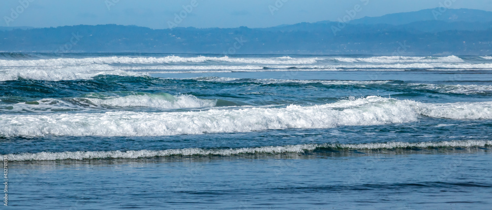 A series of multiple turbulent waves roll on shore at Moss Landing State Beach, along the Monterey Bay of the central coast of California. A series of multiple turbulent waves roll on shore at Moss Landing State Beach, along the Monterey Bay of the central coast of California.