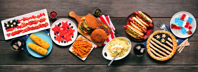Fourth of July, patriotic, American themed food. Top view table scene on a dark wood banner background. Copy space.