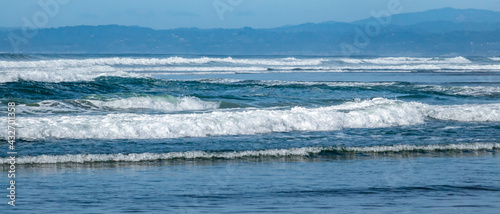 A series of multiple turbulent waves roll on shore at Moss Landing State Beach, along the Monterey Bay of the central coast of California. 