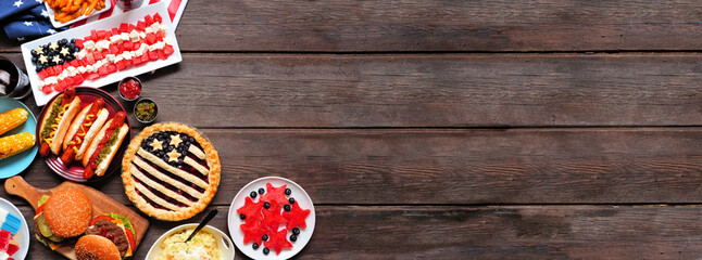 Fourth of July, patriotic, American themed food. Overhead view corner border on a dark wood banner background. Copy space.