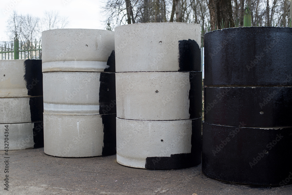 Reinforced concrete rings for the construction of sewers and wells, outside. Gray and tarred. Reinforced concrete rings for the construction of sewers and wells, outside. Gray and tarred.