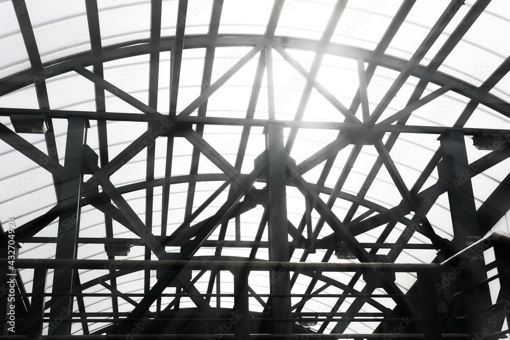 sun shines through the lattice structures of the covered pedestrian crossing