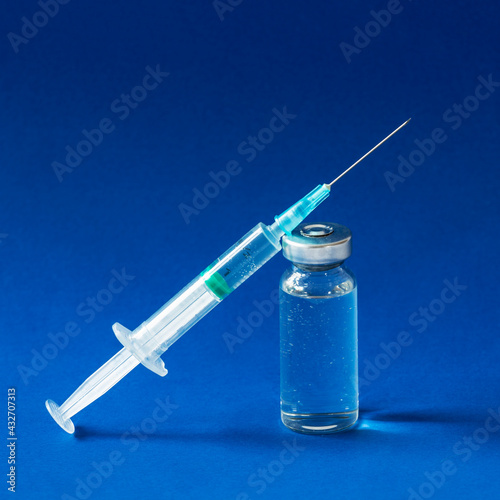 Covid-19 vaccines vials bottles with an injection syringe photo
