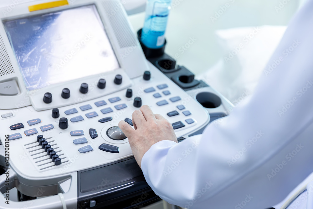 Doctor hand at ultrasound scanner control panel. Ultrasound machine ...