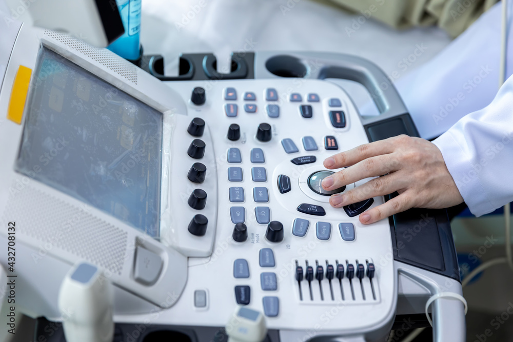 Doctor hand at ultrasound scanner control panel. Ultrasound machine Doctor hand use investigation. Doctor operating on a machine to perform ultrasounds on patients Doctor hand at ultrasound scanner control panel. Ultrasound machine Doctor hand use investigation. Doctor operating on a machine to perform ultrasounds on patients