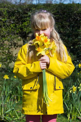 A young child with daffodils 