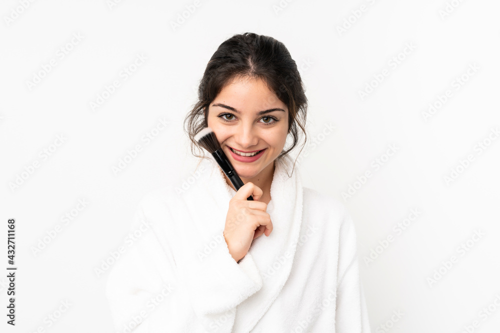 Young caucasian woman isolated on white background holding makeup brush and looking up Young caucasian woman isolated on white background holding makeup brush and looking up