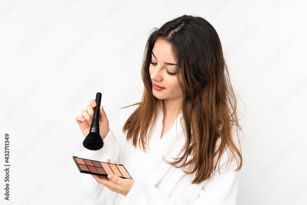 Young caucasian woman isolated on white background with makeup palette Young caucasian woman isolated on white background with makeup palette
