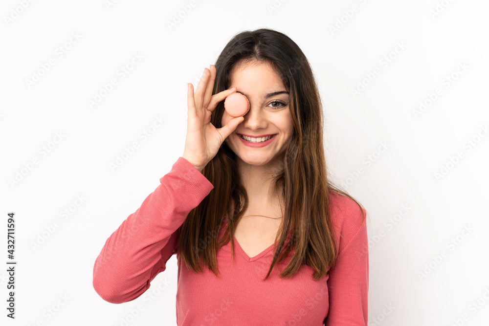 Young caucasian woman isolated on pink background holding colorful French macarons Young caucasian woman isolated on pink background holding colorful French macarons