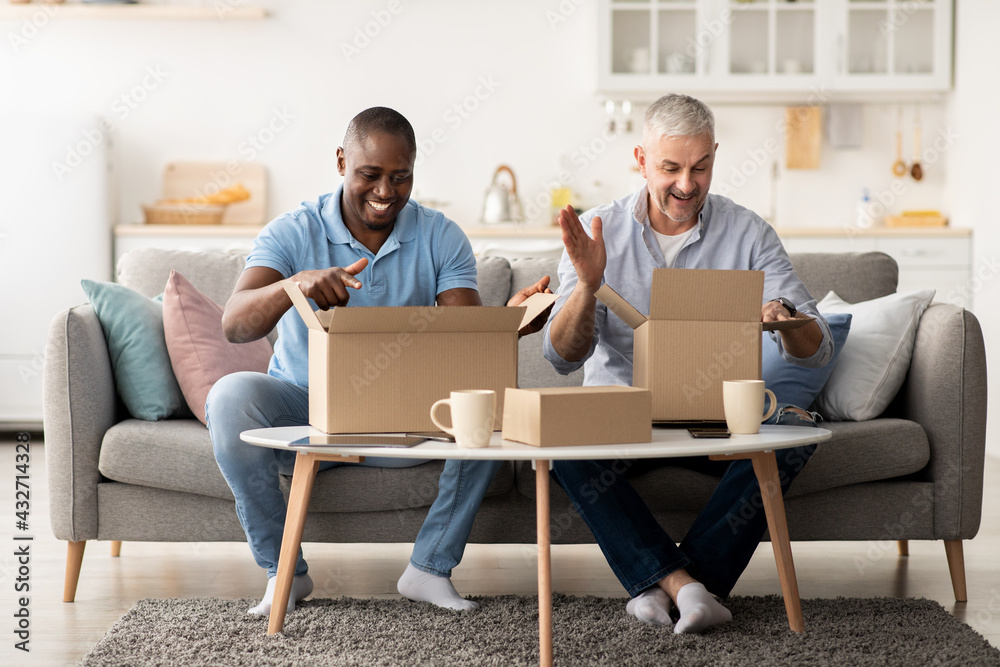 Satisfied clients looks in boxes, excited by good delivery service, received online store order, gift Satisfied clients looks in boxes, excited by good delivery service, received online store order, gift