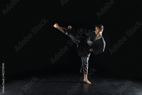 Bild auf Leinwand Male karateka, fighter in black kimono, training