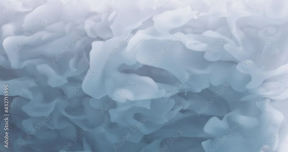 Abstract Macro slow motion shot of Blue and white swirling forms. fluid smoke mixing in water, swirling softly underwater. Cloud of ink. Colored abstract smoke or fluid motion animation.