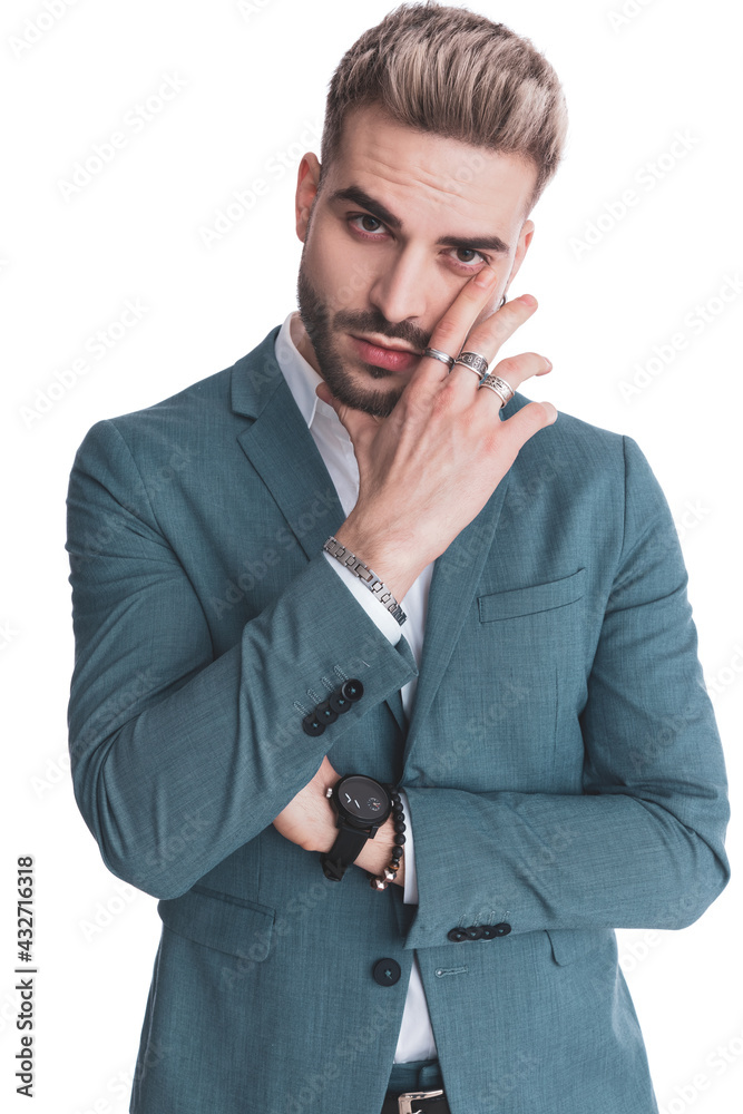 sexy businessman in suit crossing arms and holding hand to face sexy businessman in suit crossing arms and holding hand to face