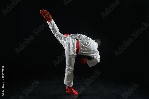 Karateka, fighter in white kimono and red gloves