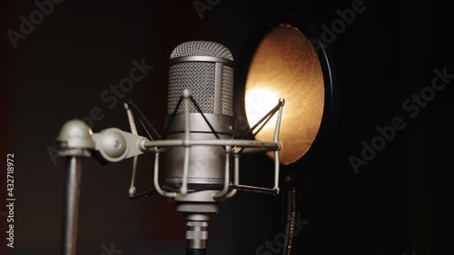 Professional microphone for dubbing and voice over in the sound recording studio. Close up, podcasting concept.