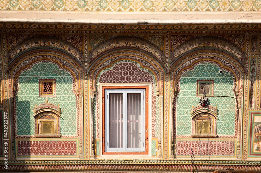 Stunning view of a colorful decoration around some windows in Jaipur, India. Jaipur is the capital  of Rajasthan, and the City Palace was the administrative seat of the Maharaja of Jaipur.