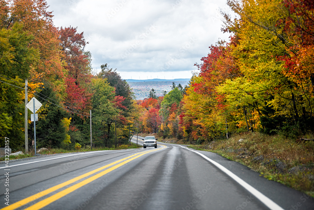 Canaan valley near Davis, West Virginia during colorful autumn fall season with red maple trees foliage on road trip scenic highway 32 and car Canaan valley near Davis, West Virginia during colorful autumn fall season with red maple trees foliage on road trip scenic highway 32 and car