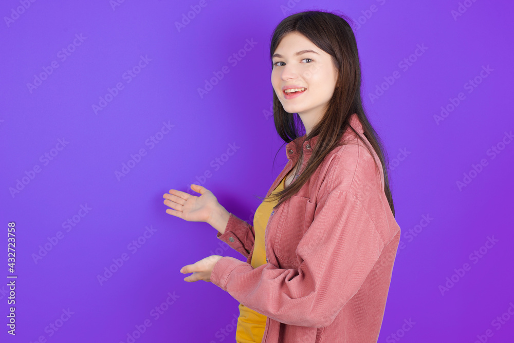 young beautiful Caucasian woman wearing casual clothes over purple wall Inviting to enter smiling natural with open hands. Welcome sign. young beautiful Caucasian woman wearing casual clothes over purple wall Inviting to enter smiling natural with open hands. Welcome sign.