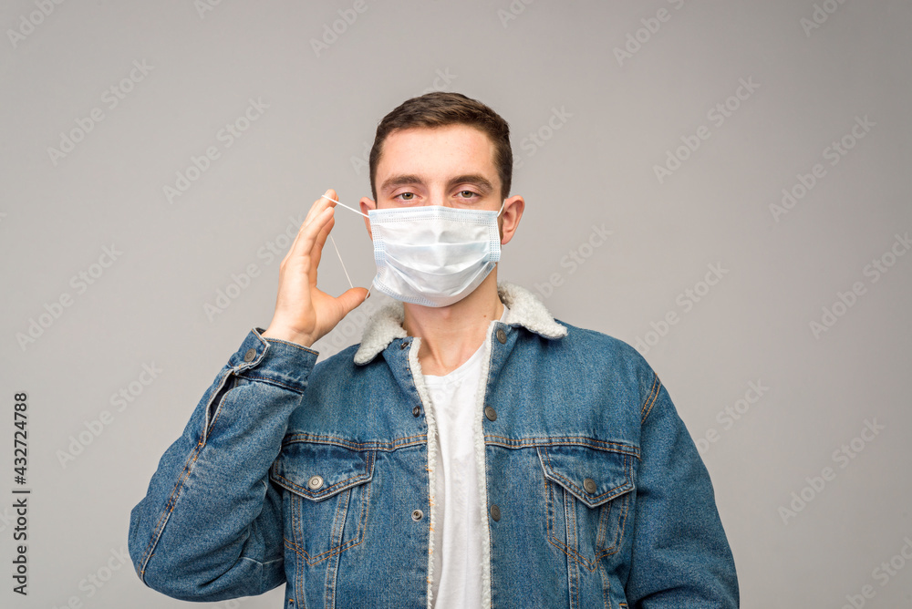 A portrait of a man who puts on a medical mask. The concept of protecting yourself during a pandemic A portrait of a man who puts on a medical mask. The concept of protecting yourself during a pandemic