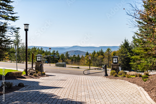 Fototapeta Naklejka Na Ścianę i Meble -  Snowshoe, West virginia small Allegheny mountain ski resort town with view on mountains and street road by sidewalk in autumn fall