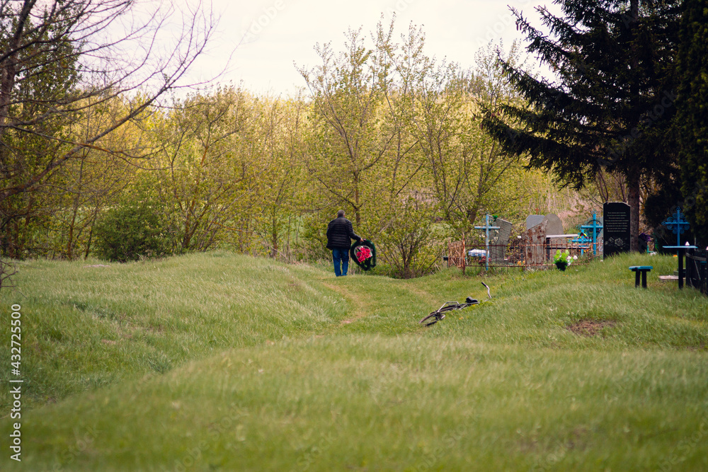Cherevki village, Ukraine - May 09, 2021: people on the cemetery during funeral Sunday orthodox church Cherevki village, Ukraine - May 09, 2021: people on the cemetery during funeral Sunday orthodox church