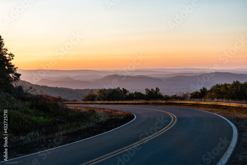 Fall autumn season with sunrise at winding Highland Scenic highway 150 road in West Virginia Monongahela National Forest Appalachian mountains photo