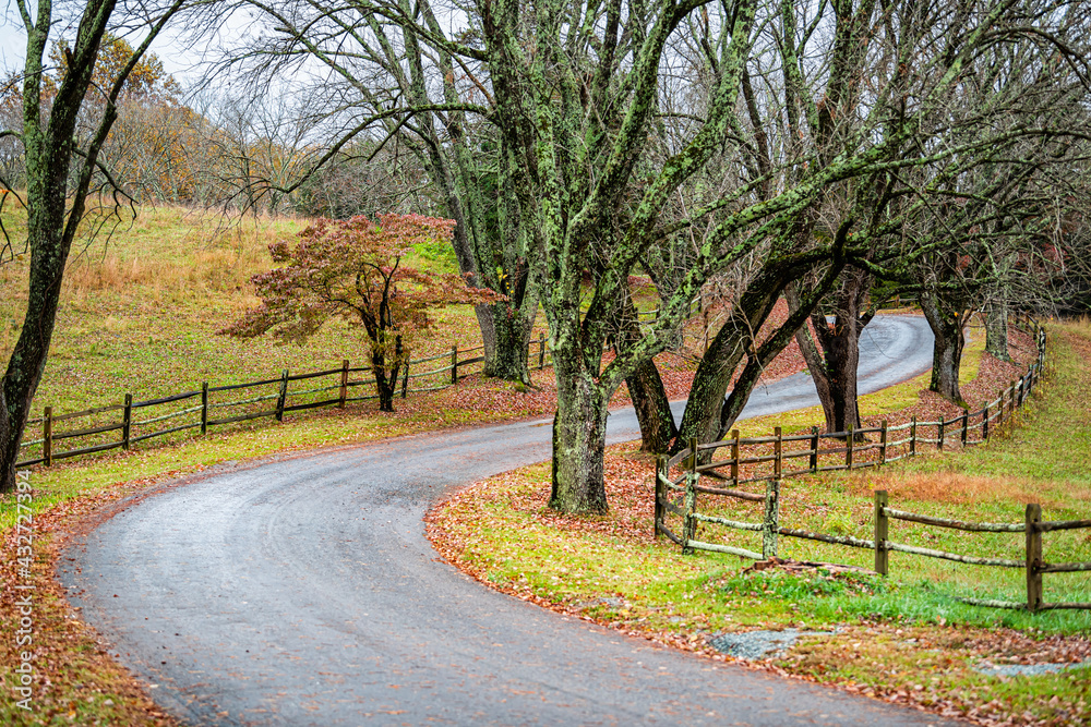 Countryside narrow rural winding paved road to Ash Lawn-Highland, Home of US President James Monroe in Albemarle County, Virginia in colorful autumn