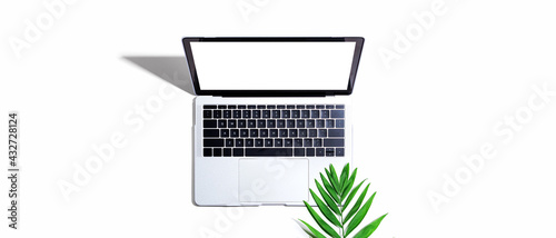 Laptop computer with tropical leaf