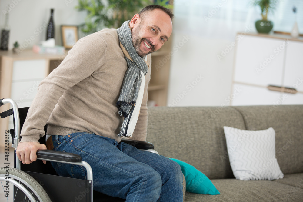 disabled man trying to sit on the sofa