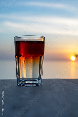 romantic evening with a drink during the sea sunset