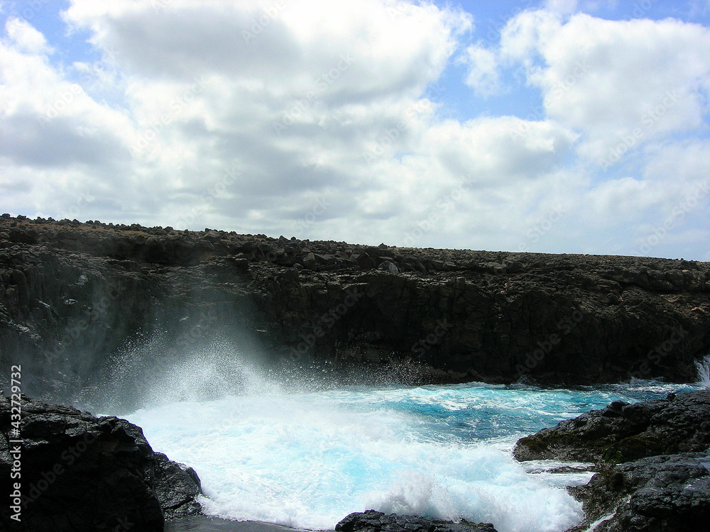 Marine wave breaking on the rocks of the Barracona cave, Sal Island, Cape Verde