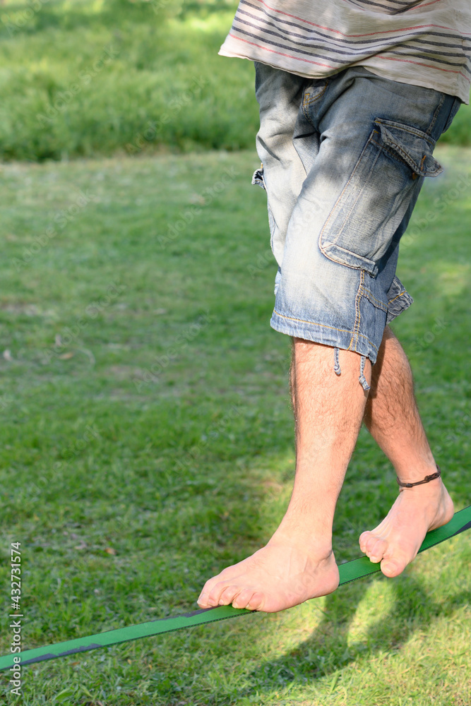 Fototapeta premium Legs of a man on a tightrope.