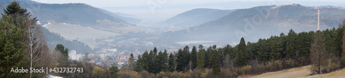 Panorama of a city in a valley between hills in winter in the morning