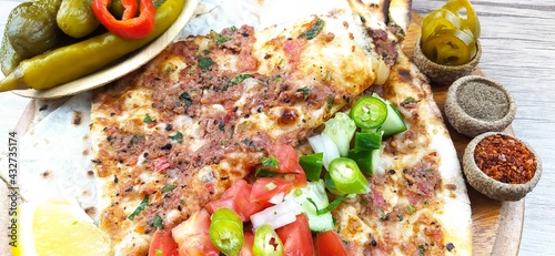 Turkish specialty pizza lahmacun pide with parsley and lemon photo